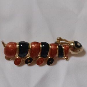 Elegant Gold and Black Caterpillar Brooch